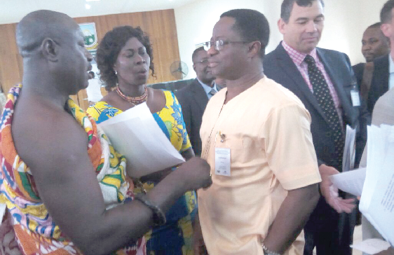 Mr Peter Amewu (middle) interacting with some of the participants after the opening