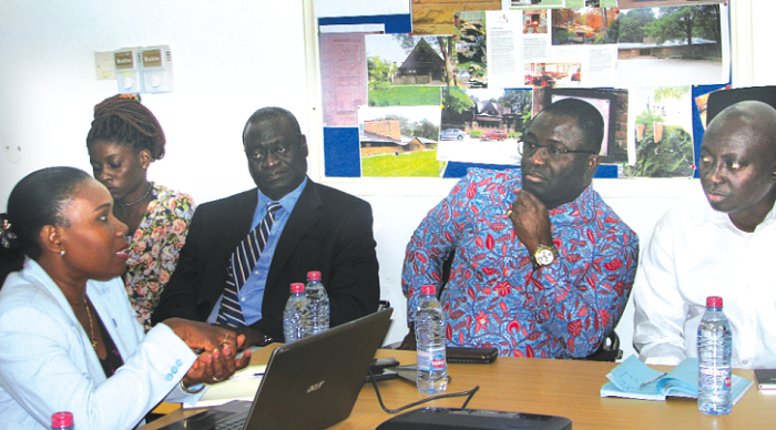 Mrs Stella Arthiabah (left), Registrar of the Architects Registration Council, explaining a point to Mr Samuel Atta Akyea (right). With them are other officials of the council. Picture: ESTHER ADJEI