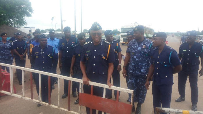 Commissioner of the Customs Division of the GRA , Mr Isaac Crentsil (3rd right) removing the Customs barrier at Yapei in the Northern Region to start the official removal of the Customs barriers