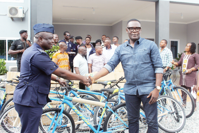 Mr Humphery Awuletey-Williams (right) presenting the bicycles to ACP Owusu-Boateng (left). Picture: Obed Duku