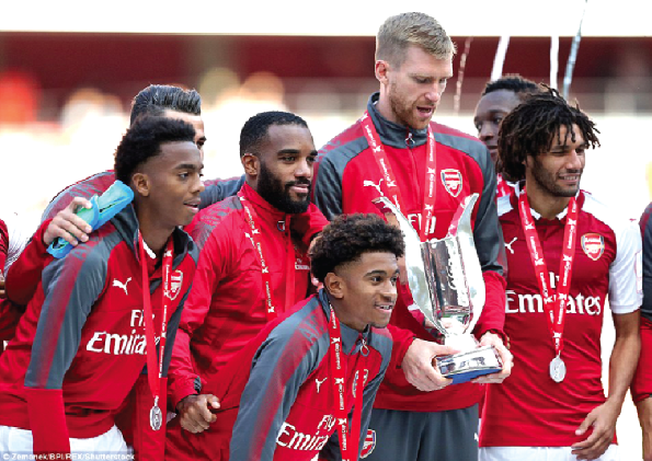 Arsenal captain Per Metersacker (with the trophy) and teammates after winning the Emirates Cup yesterday.