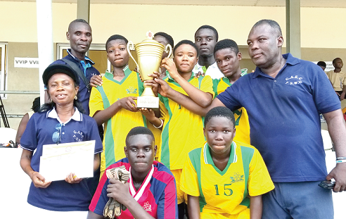 Some players and officials of the GAEC Basic School with the winner’s trophy.