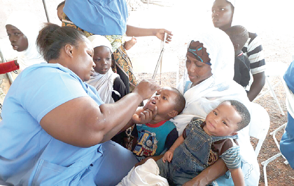  One of the health workers immunising children at Asokore Mampong to mark World Polio Eradication Day