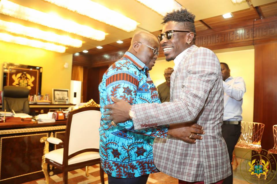 Shatta Wale and President Akufo-Addo hugging in their meeting at flagstaff house