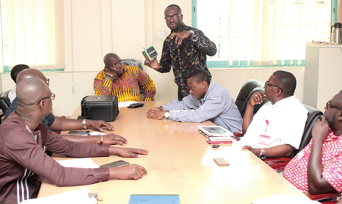 Mr Benjamin Bonsu (standing), leader of the GhanaSat-1 trio, briefing the Daily Graphic editorial board at the meeting. Picture: NII MARTEY M. BOTCHWAY