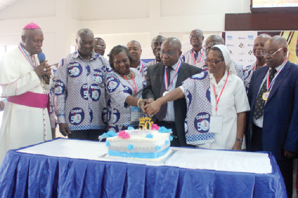 Mr Kwaku Agyeman-Manu (middle), the Minister of Health,  Dr Agatha A. Bonney (3rd left) and some CHAG executives cutting the 50th anniversary cake.