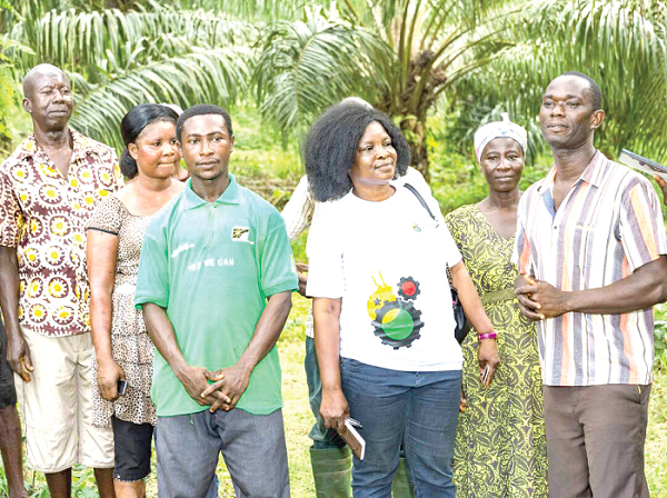  Mrs Gifty Ohene Konadu (2nd right), National Coordinator of the One-District-One-Factory secretariat interacting with some farmers during the visit