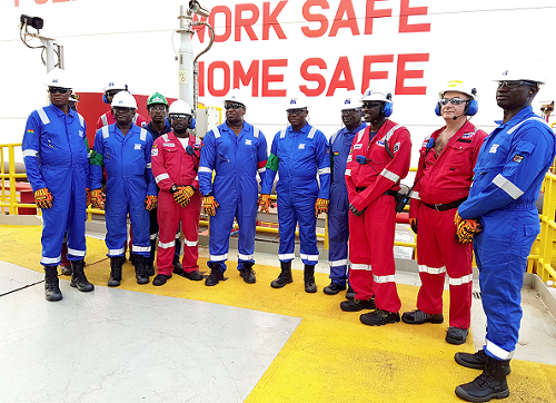 Mr Dominic Nitiwul (5th right), Gen. Obed Asamoah Akwa (4th right) and other army officers being conducted round one of the FPSOs
