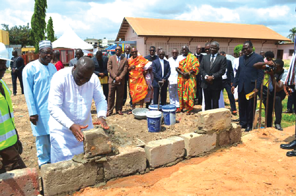 Mr Vincent Odotei Sowah, a deputy Minister of Communications, laying a block for the construction of the building