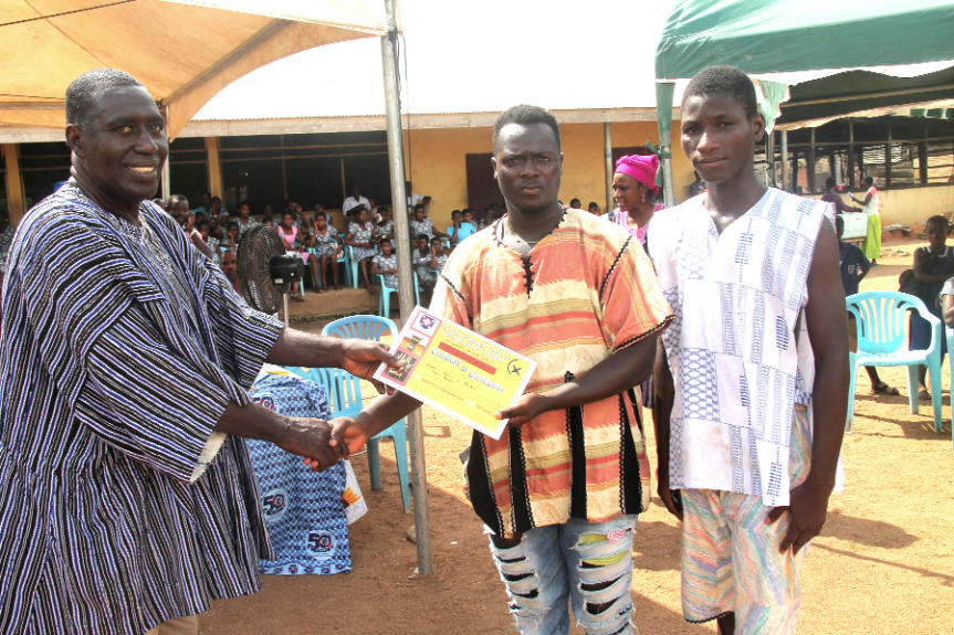  Mr David Aning Yebo (left), Headmaster of NPSHS, presenting a certificate of participation to representatives of Swedru School of Business.