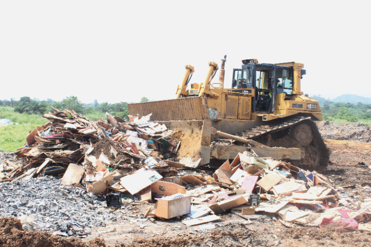 An excavator destroying some of the confiscated machines