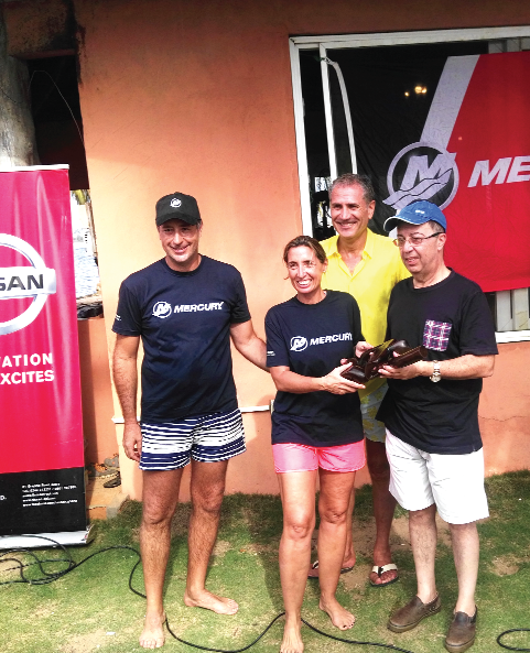 Mr Ali Halabi (right), the Lebanese Ambassador to Ghana, assisted by Mr Accad of Auto Parts Limited presenting the  trophy to Alicia Del Pesso and David Carreras