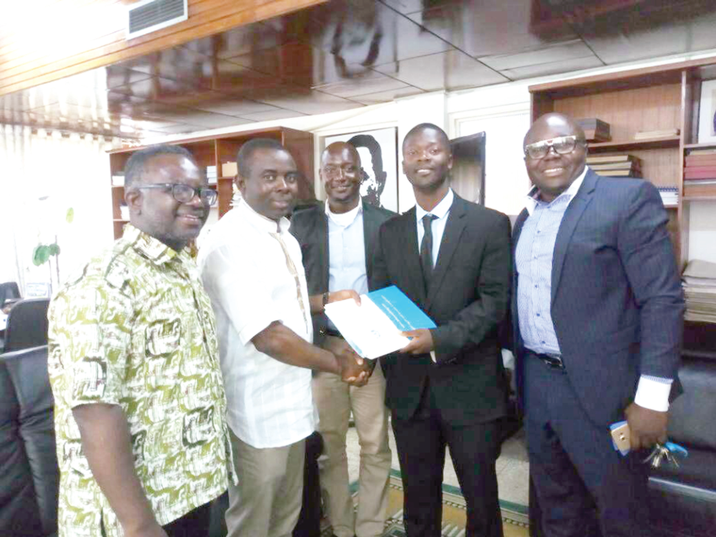 Mr Kojo D. Darko (2nd right) presenting the report to Prof. Joshua Yindenaba Abor