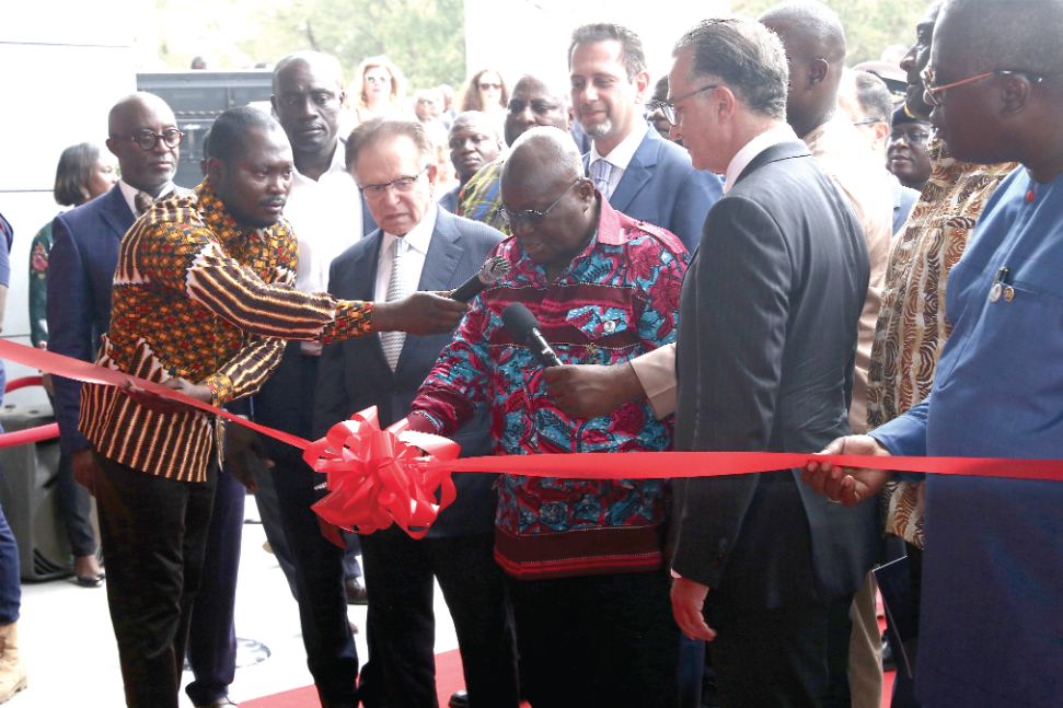 President Akufo-Addo being assisted by officials of Dream Realty to cut the tape to inaugurate the Octagon building
