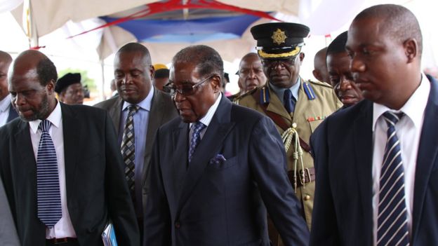 Mr Mugabe (C) arrived with a military escort