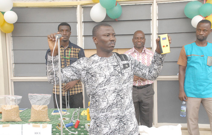  Mr Joseph Akowuah demonstrating how the moisture meter works