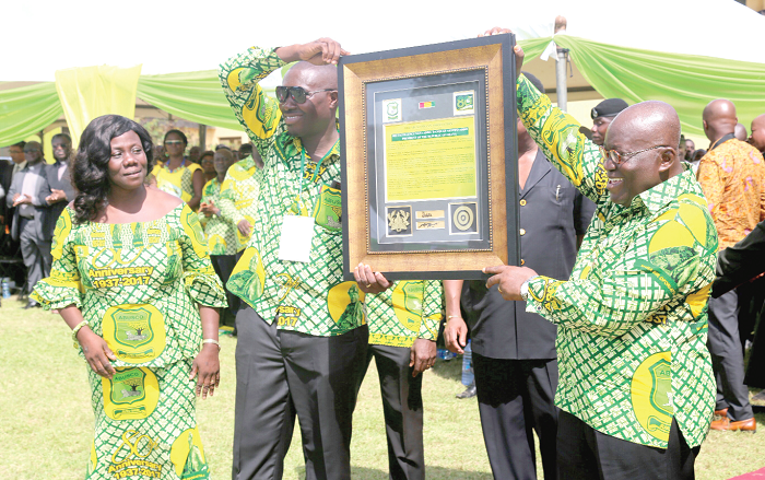 President Akufo-Addo receiving a citation from the anniversary planning committee of ABUSCO