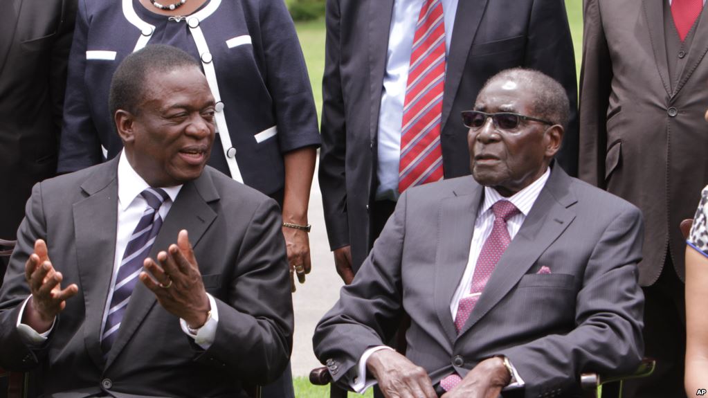 Flash back: Emmerson Mnangagwa, left, former Vice President of Zimbabwe chats with Zimbabwean President Robert