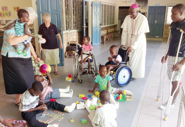Sister Elizabeth Newman (left), the Coordinator of the Orthopaedic Centre and the Catholic Bishop of Koforidua, Most Rev. Joseph Afrifah-Agyekum, interacting with some of the children receiving treatment at the centre