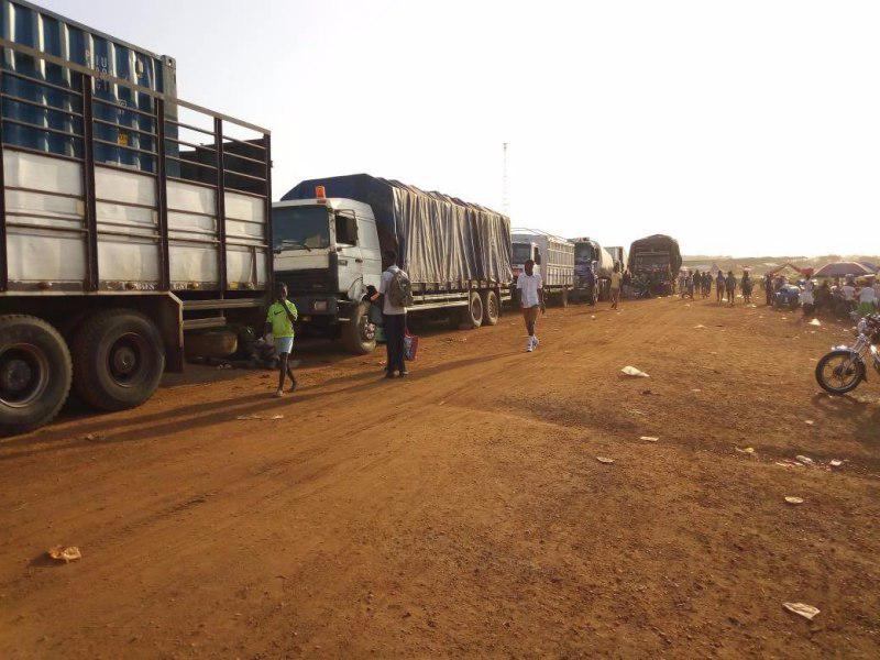 Some trucks awaiting their turn to cross over the Volta River at Yeji