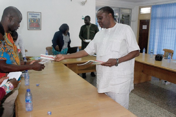 The Executive Secretary of the EFCC, Mr E.A. Aremo, presenting some brochures on the EFCC to the Head of the investigative desk of the Multi Media Group of Companies, Mr Manasseh Azure Awuni