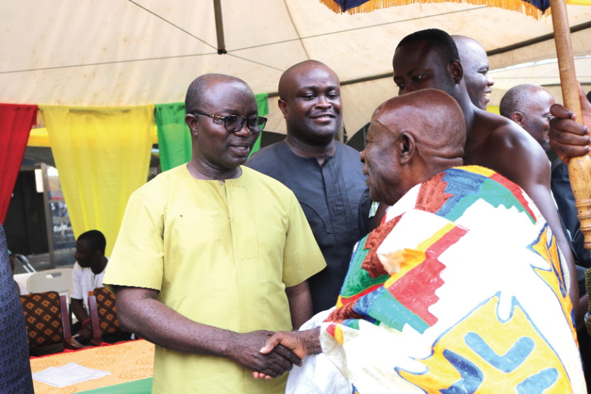  Mr Osei Assibey Antwi (left) in a handshake with the Tafohene, Nana Agyen Frimpong, during the town hall meeting 
