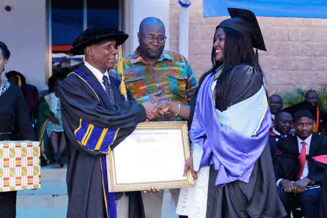 Prof. Kwasi Ansu Kyeremeh (left) being, assisted by Mr Kojo Larbi (middle), Representative of Stanbic Bank to present the Overall Best Student award (Degree) to Ms Ruth Bazing at the GIJ congregation 2017