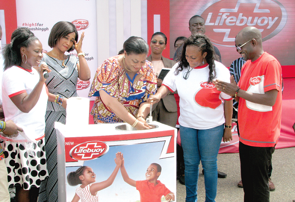  First Lady Mrs Rebecca Akufo -Addo (middle) washing her hands at the event.  With her are Ms Otiko Afisah Djaba (2nd right), the Minister for Gender, Children and Social Protection, and other officials. Pictures: ESTHER ADJEI 