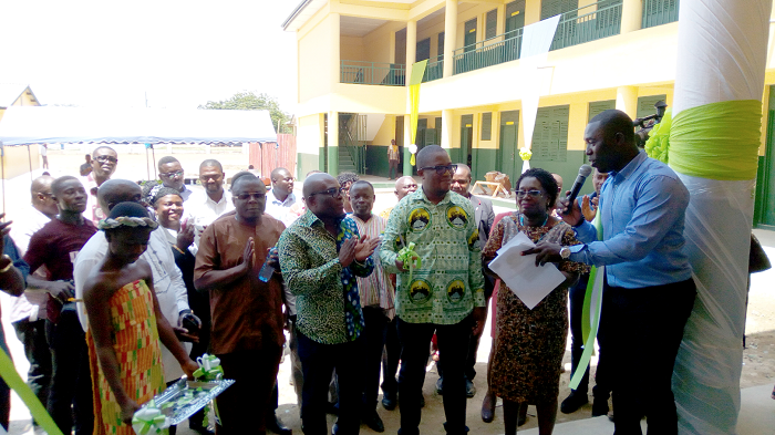  Dr Emmanuel Lamptey (3rd right) cuts the tape to inaugurate the block. With him include Ms Denise Dinah Welbeck (2nd right) and  Mr Aristo Aryee, former MCE of Ga Central Municipal Assembly (4th right)