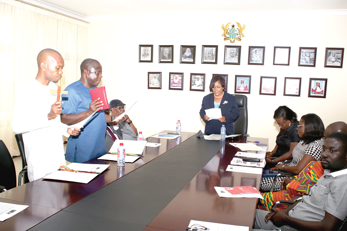 Justice Vida Akoto Bamfo swearing in the two new members of the NMC