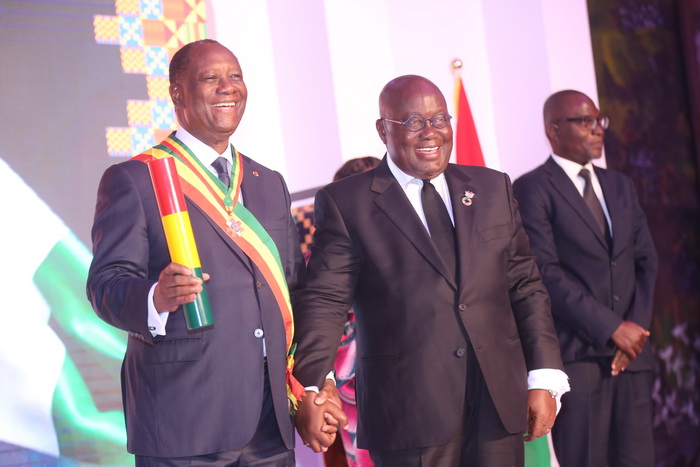 President Alassane Ouattara displaying his award after it was presented to him by President Akufo-Addo at the event