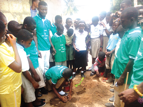 Some of the pupils  observing the tree-planting exercise