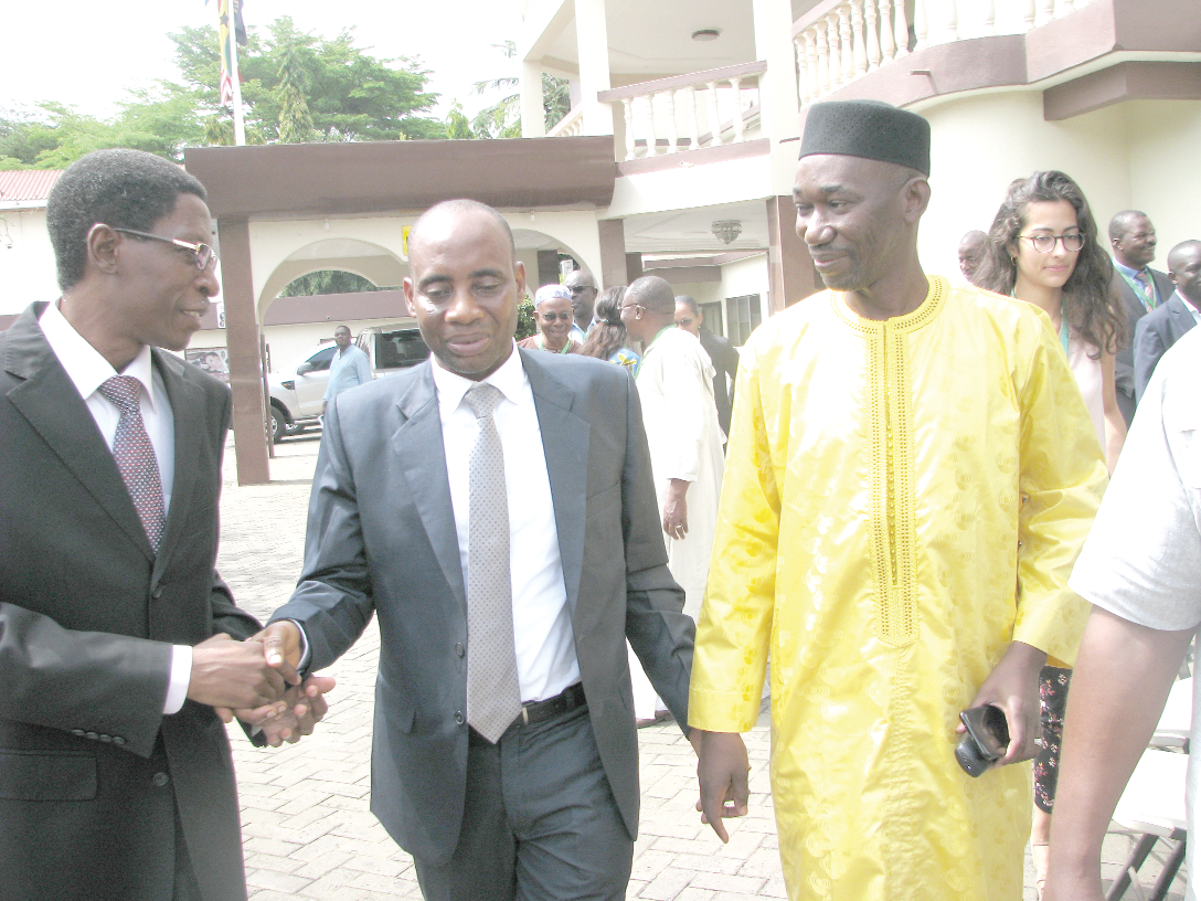  Mr Sagre Bambangi (middle), a Deputy Minister of Food and Agriculture, chatting  with Mr Ousseini Salifou ( left), Executive Director of the ECOWAS Regional Agency for Agriculture and Food (FAAF). Looking on is Mr Youssouf Maiga (3rd right), Chairman and Chief Executive Officer of the Office of the Food Security Commissioner after the meeting