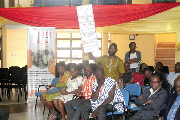 A participant holding a placard during the forum.  Picture: Maxwell Ocloo