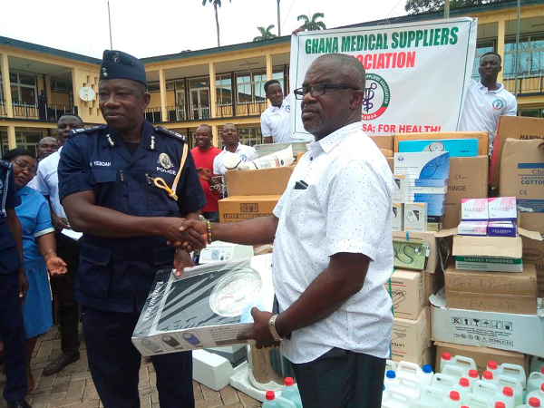  Nana Amoah Nyame (right) in a handshake with COP Mr Ken Yeboah, after presenting the instruments