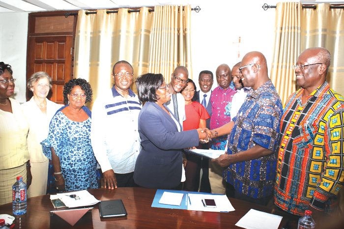 Sir Kt. Bro. Eddie Pra (right), Outgoing Chairman of Maredes handing over a file of office to RL. Sister Anderson Yebuah, the newly elected Chairperson of Maredes