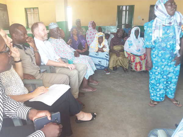 Philip Smith (4th left) and Peter Badimak Yaro (3rd left) interacting with some beneficiaries of mental health support