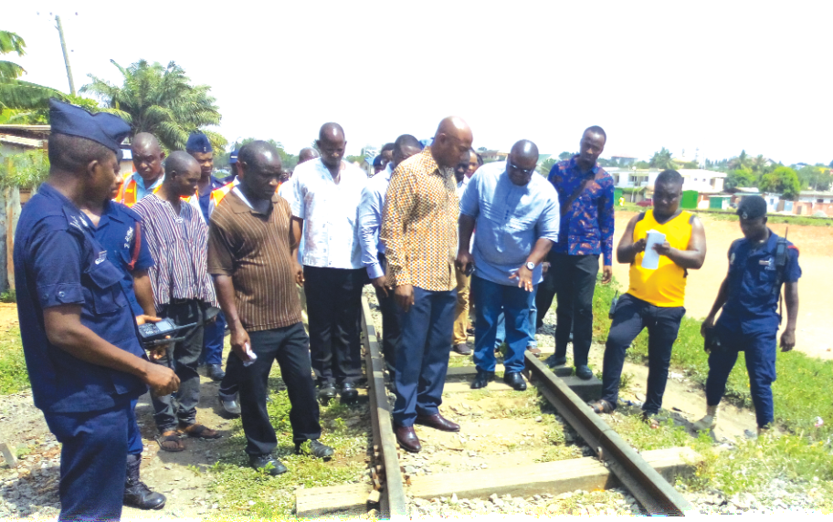 Mr Kweku Agyenim Boateng (5th right) being conducted round the rail lines at Achimota by officials of the GRDA