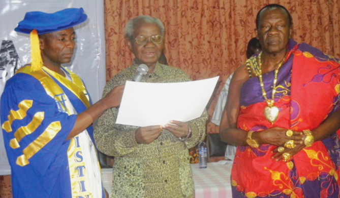 Emeritus Professor Nketia reading the citation on the occasion of the conferment of the Distinguished Fellow (DF) Award on Daasebre Oti Boateng (right) by the Distinguished Scholars of Africa in December 2013.