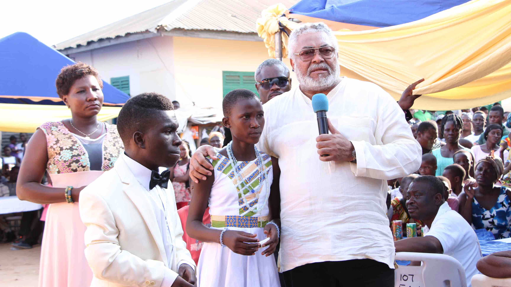 The former President  with the beneficiaries,  Maxwell and Naomi by his side while addressing the durbar