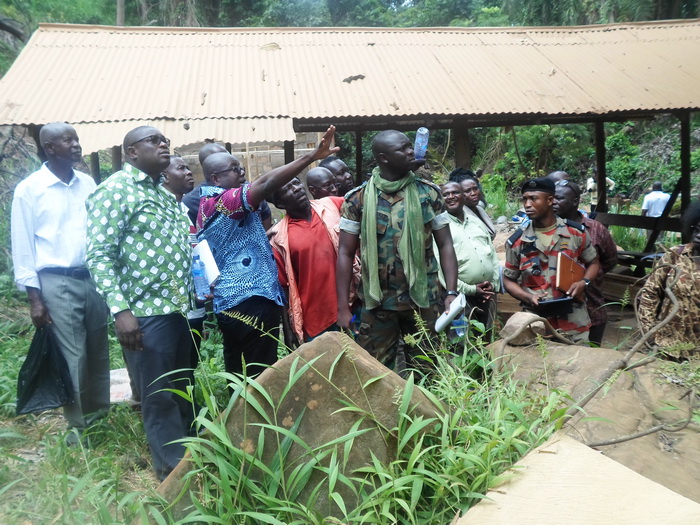 The Project Officer, Capt Adonawra of the 48 Engineering Regiment, leading Mr Agyeman (hand raised) to inspect the new changing room being constructed down the Kintampo Waterfalls