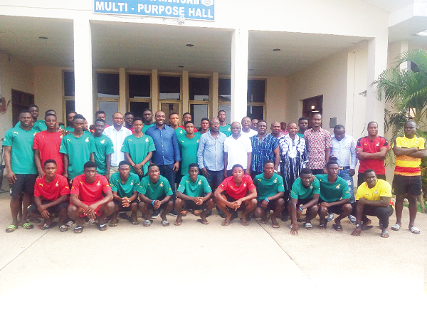 The Sports Minister (arrowed) and other officials pose with the Black Starlets and techinical handlers after the visit last Friday