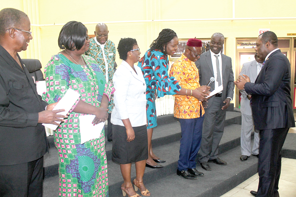 Dr Matthew Opoku Prempeh (right), the Minister of Education, congratulating some members of the governing council for the Accra, Kumasi, Ho, Takoradi, Sunyani and Koforidua Technical Universities after the inauguration. Picture: EDNA ADU-SERWAA