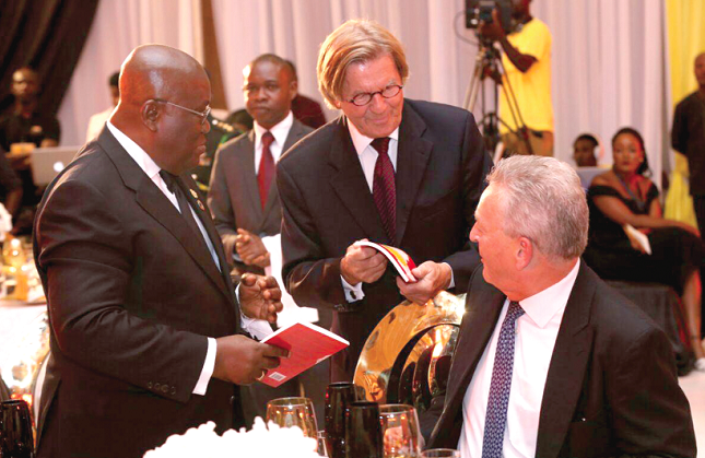  Mr Jan Dege (middle), First General Manager, Ghana Cement Limited, showing a book to  President Akufo-Addo (left) and Mr Morten Fade, Managing Director, Ghacem, at the event. Picture: SAMUEL TEI ADANO