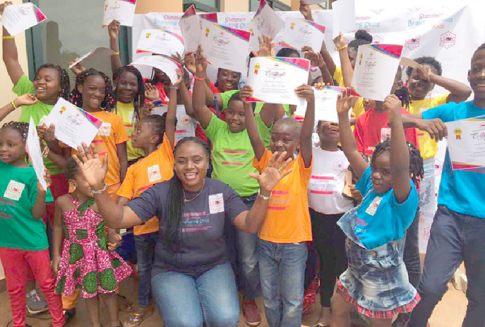 Mrs Latifa  Adekanla (front), in a pose with some of the children after a ceremony to end the training programme. (Inset) The products they made on display.