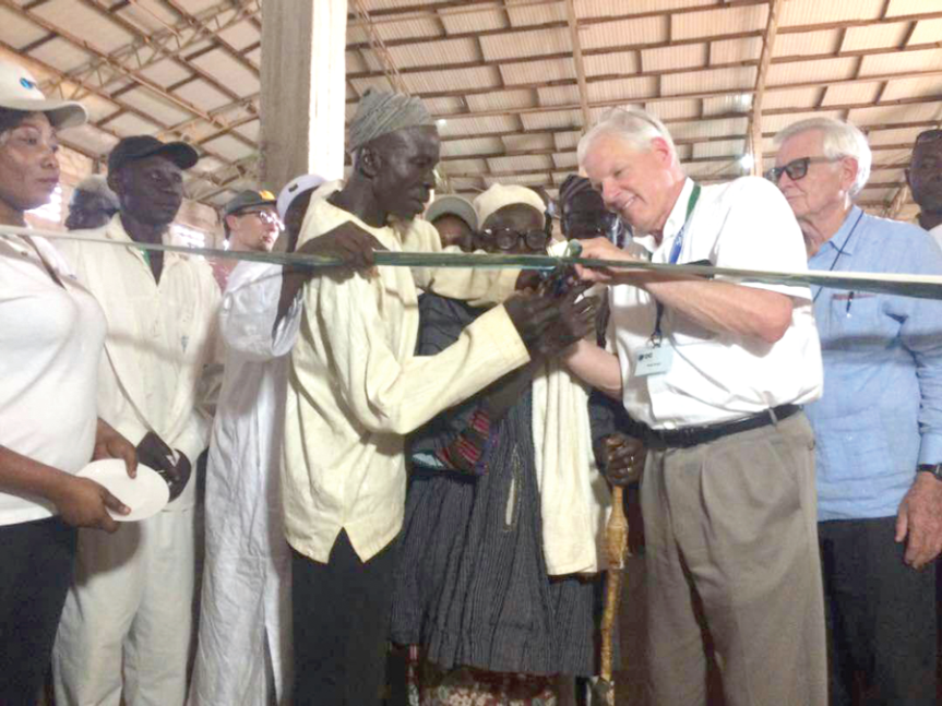  Dr Angle (in white shirt) being assisted by the Shishegu-Naa to cut the tape to inaugurate the facility