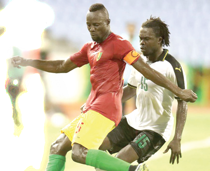 Guinea captain Youssouf Camara shields the ball away from Stars’ striker Stephen Sarfo during yesterday’s Group A clash in Cape Coast