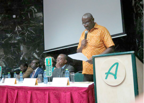 Mr Eric Quaye (standing) addressing the forum, while Mr Stephen Antwi (2nd right) President, GGEA and other dignitaries listen 