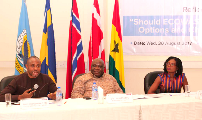Mr Chukwuemeka B. Eze (left), Executive Director,  WANEP, explaining a point. Those with him are Dr Thomas Jaye (middle), Head of Consultancy, KAIPTC, and Dr Emma Birikorang (right), acting Deputy Director, Faculty of Academic Affairs - KAIPTC.