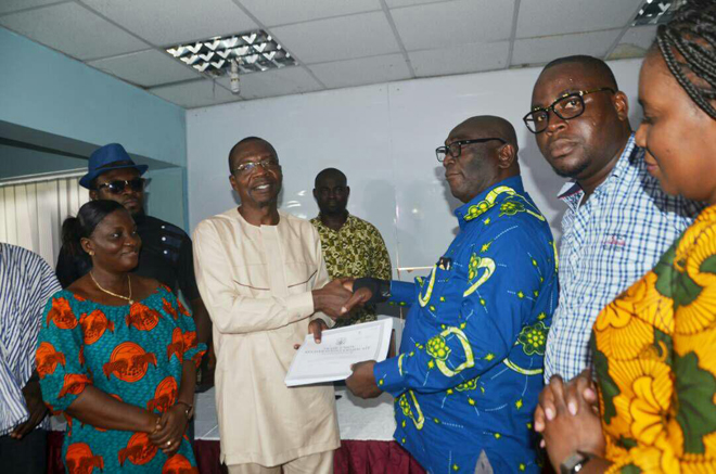 Mr Roland Affail Monney, GJA President receiving the certificate from Brother Joshua Ansah, Deputy Secretary General of the TUC at the press conference on Friday